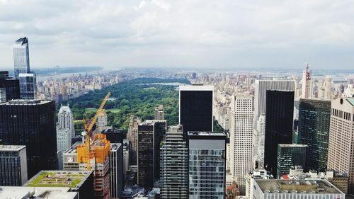 High angle view of modern buildings in city against sky