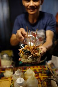 Midsection of man preparing food