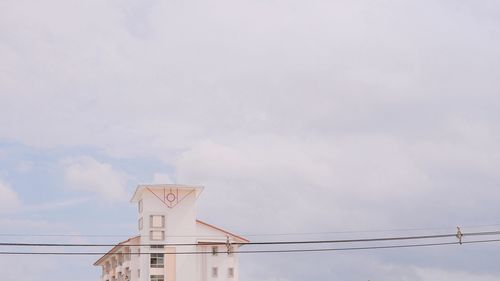 Low angle view of communications tower against sky