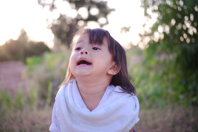 Portrait of cute girl standing outdoors