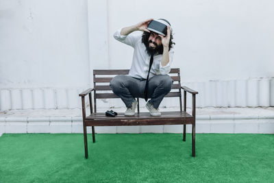Young man sitting on chair at park