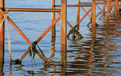 Close-up of rusty pier over sea