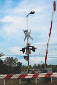 Low angle view of street lights against sky