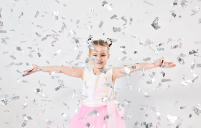 Portrait of happy girl with arms raised