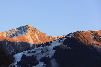 Scenic view of snowcapped mountains against clear sky