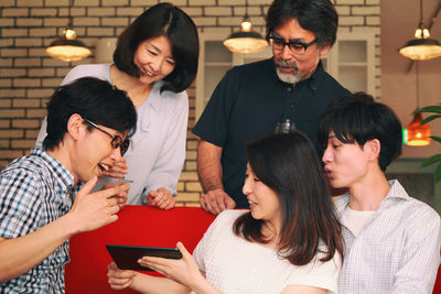 Happy family using phone at home