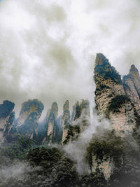 Low angle view of waterfall against sky