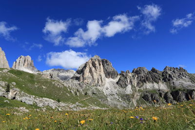 Scenic view of mountains against blue sky