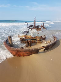 Scenic view of sea against sky with an old barge