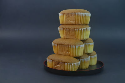 Close-up of cupcakes on table against black background