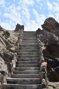 Low angle view of steps on mountain against sky