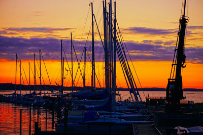 Sailboats in marina at sunset