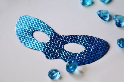 Close-up of blue paint on table against white background