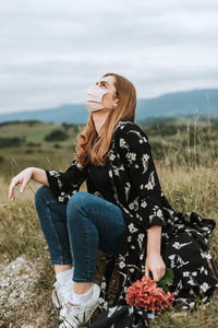 Woman sitting on field