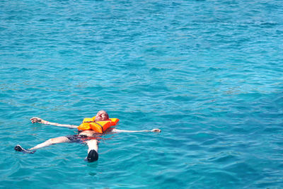 High angle view of man surfing in sea