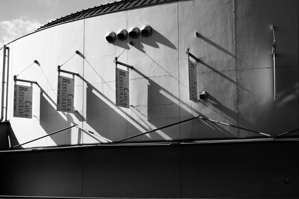 architecture, building exterior, built structure, low angle view, building, window, sky, residential building, power line, cable, city, residential structure, no people, day, outdoors, modern, sunlight, auto post production filter, street light, railing