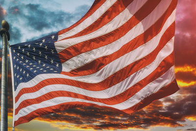 Low angle view of flags against sky during sunset