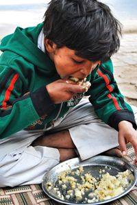 Boy eating on the street