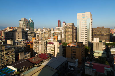 High angle view of buildings in city against clear sky