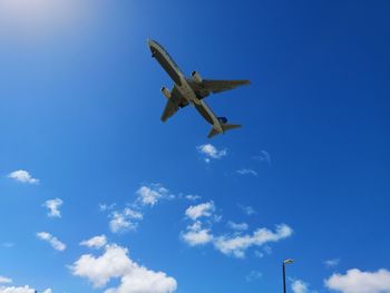 Low angle view of airplane flying in sky