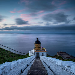 St abbs head lighthouse at sunset by the village of st abbs in berwickshire, scotland