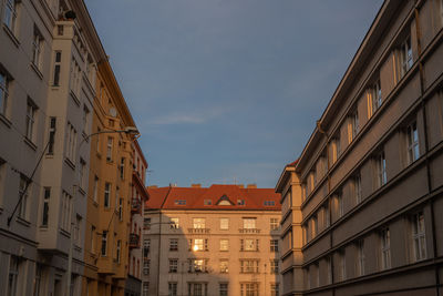 Low angle view of buildings in town against sky