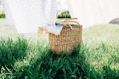 Wicker basket filled with washing ready to be drying on a line