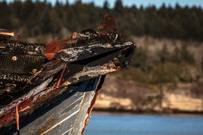 Abandoned boat on rusty metal against sky