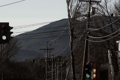 Low angle view of electricity pylon against sky
