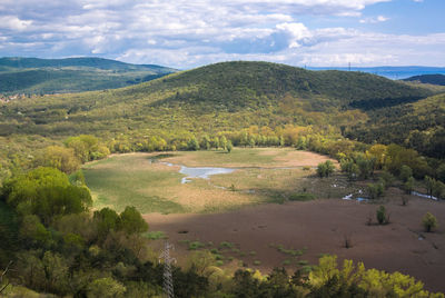 Scenic view of landscape against cloudy sky