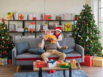 People sitting on sofa at home