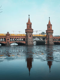 Bridge over river with buildings in background