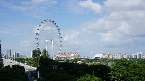 Ferris wheel in city against sky