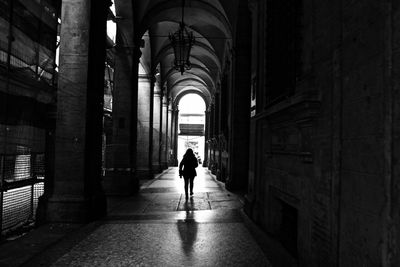 Rear view of woman walking in corridor