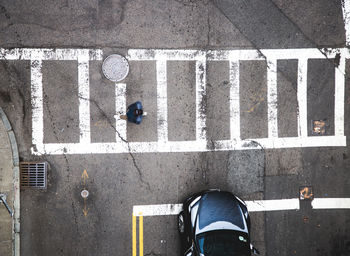 Low section of man standing on road