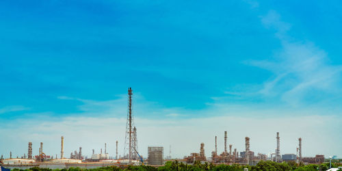 Panoramic view of factory against blue sky