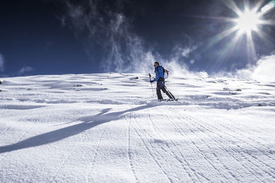 Full length of person skiing on snowcapped mountain against sky