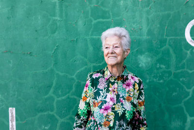 Portrait of smiling woman standing in swimming pool