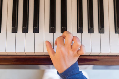 Close-up of hands playing piano