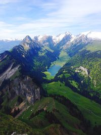 Scenic view of mountains against cloudy sky