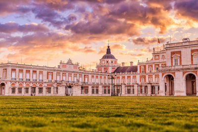 Buildings against cloudy sky during sunset