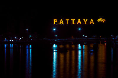 Illuminated text in city at night