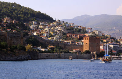 Townscape by sea against sky