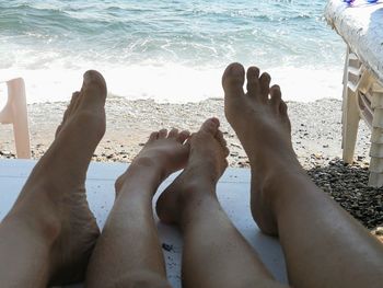 Low section of people relaxing at beach