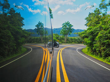 Bus moving on road against sky