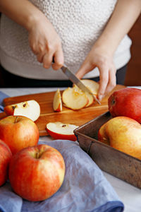 Close-up of woman preparing food on cutting board