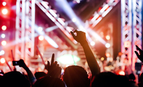 Rear view of people enjoying at music concert