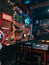 Empty chairs and tables in restaurant at night