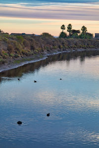 Scenic view of lake against sky during sunset