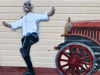 Man sitting on wood against wall